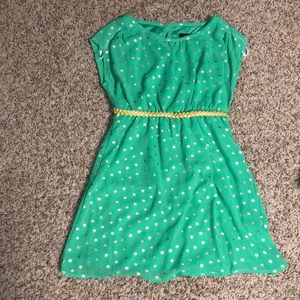 green dress with a gold belt and dots